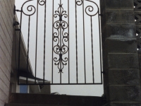 iron-anvil-gates-man-french-curve-scroll-top