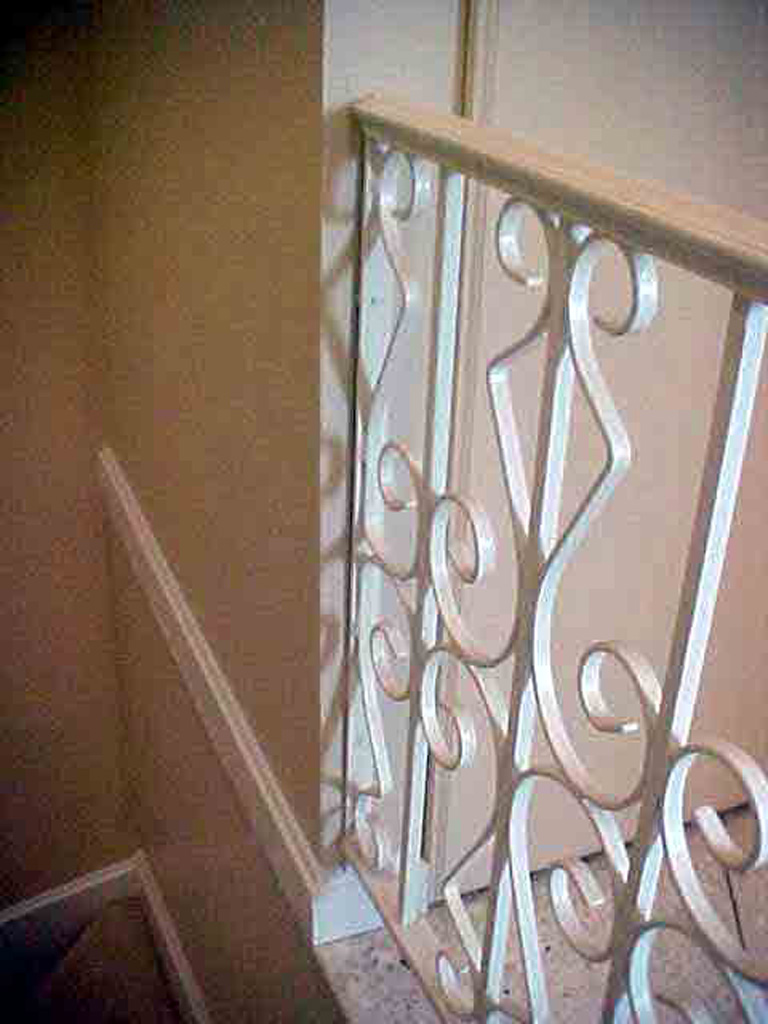 iron-anvil-railing-scrolls-and-patterns-repeating-steel-patterns-white-railing-by-others-1-2