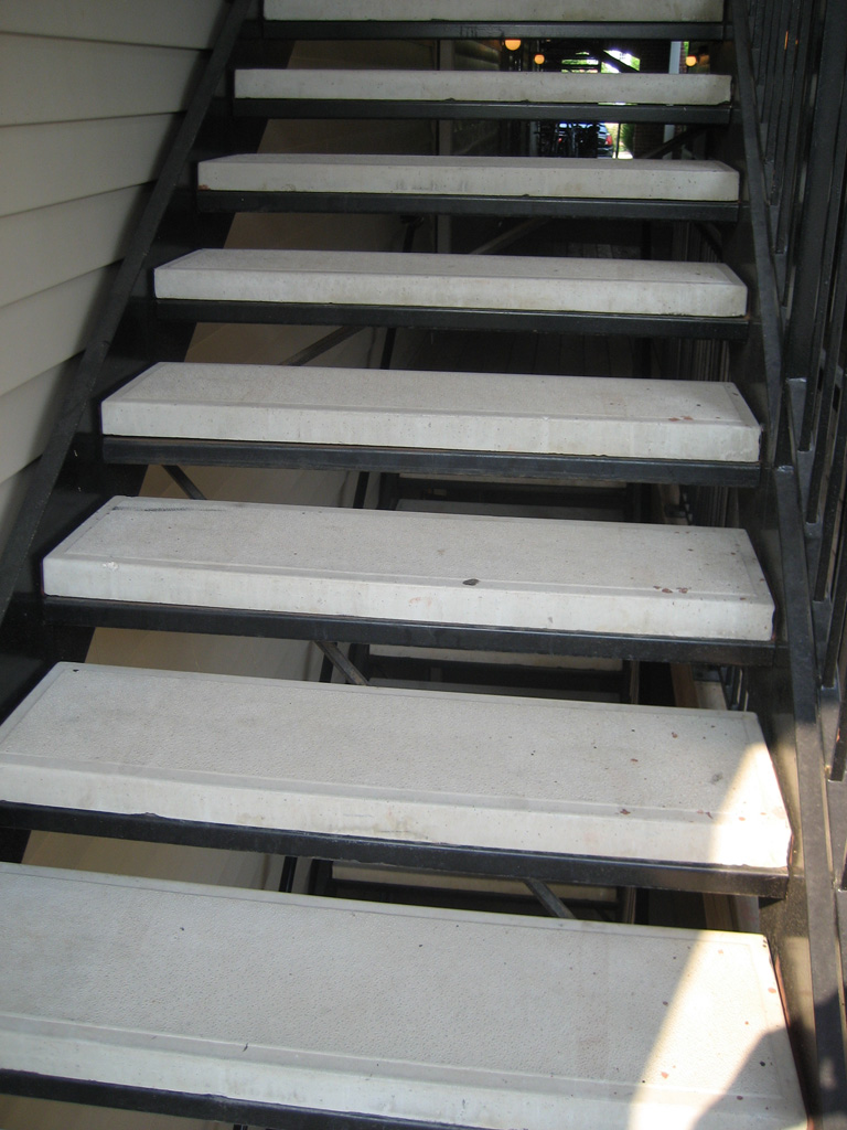iron-anvil-stairs-double-stringer-treads-concrete-smooth-by-others2