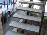 iron-anvil-stairs-single-stringer-treads-concrete-smooth-fairbanks-const-15712-stair-repair-by-others-1